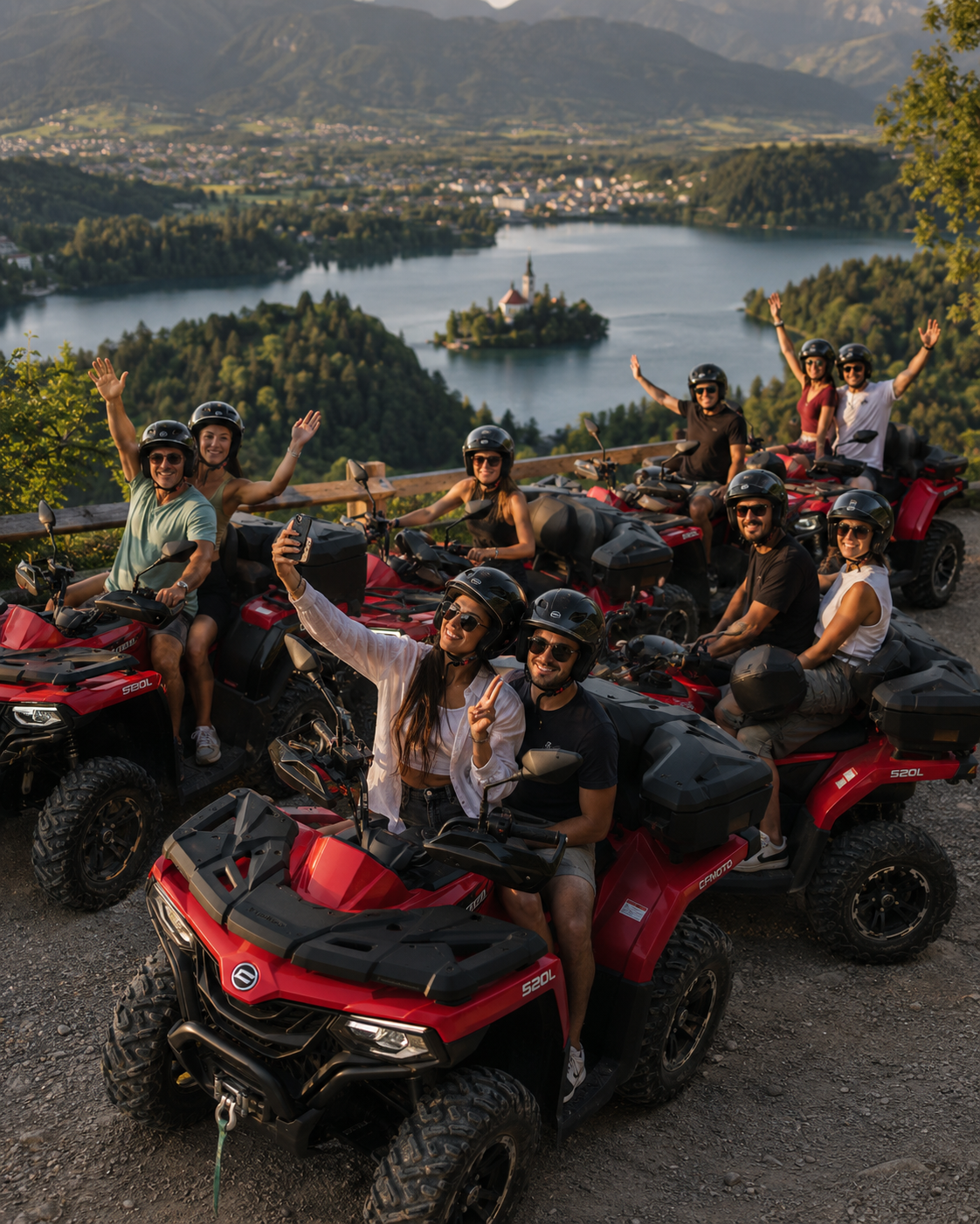 Group of friends waving from red CFMOTO ATVs and Quads at a viewpoint over Lake Bled, Slovenia