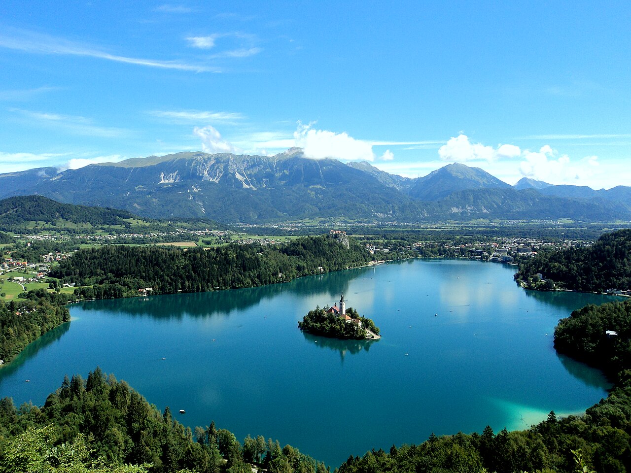 Panoramic summer view of Lake Bled with the island church from the mountain above